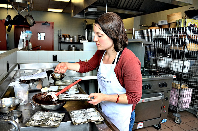 Maia Ottenstein, a product design senior, prepares chocolate madeleines for the "Chocolat" class. 